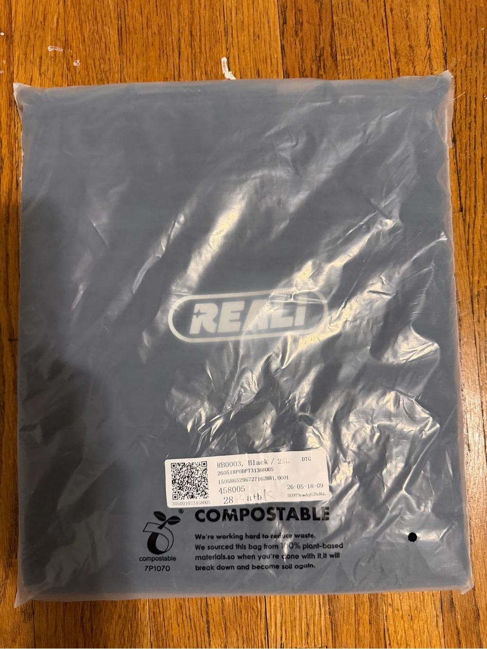 REALI Black Packaged Tee